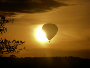 Silhouette landscape of hot air balloon against sky during sunset