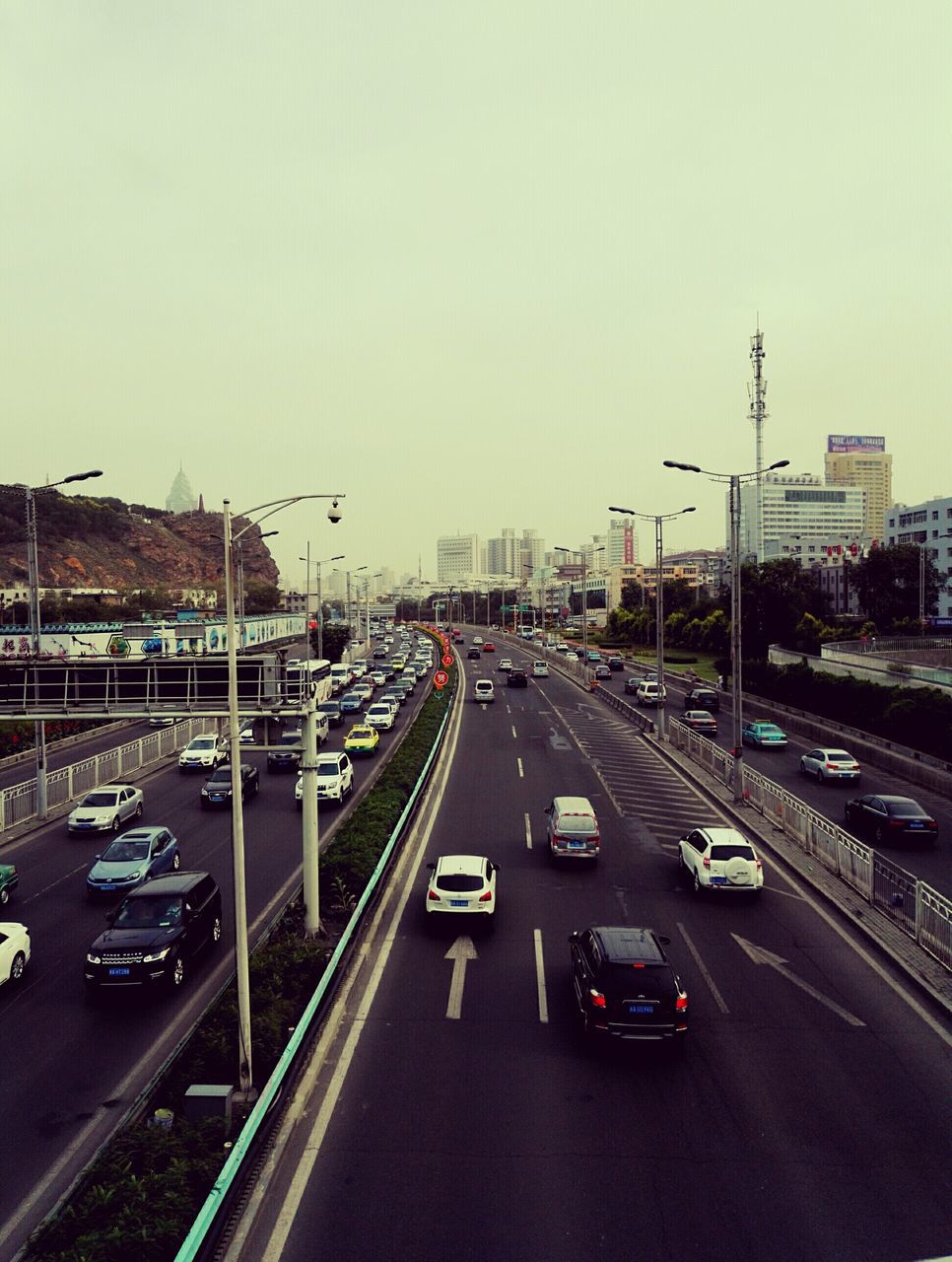 transportation, car, mode of transport, land vehicle, clear sky, city, road, architecture, built structure, building exterior, traffic, copy space, high angle view, street, road marking, on the move, street light, city life, the way forward, travel