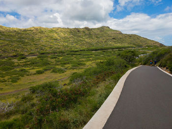 Road passing through landscape against sky