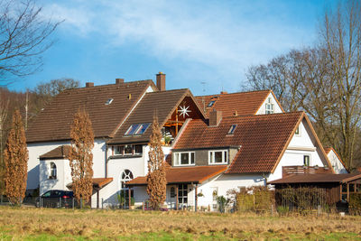 Houses on field against sky