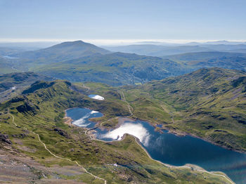 High angle view of lake amidst mountains against sky