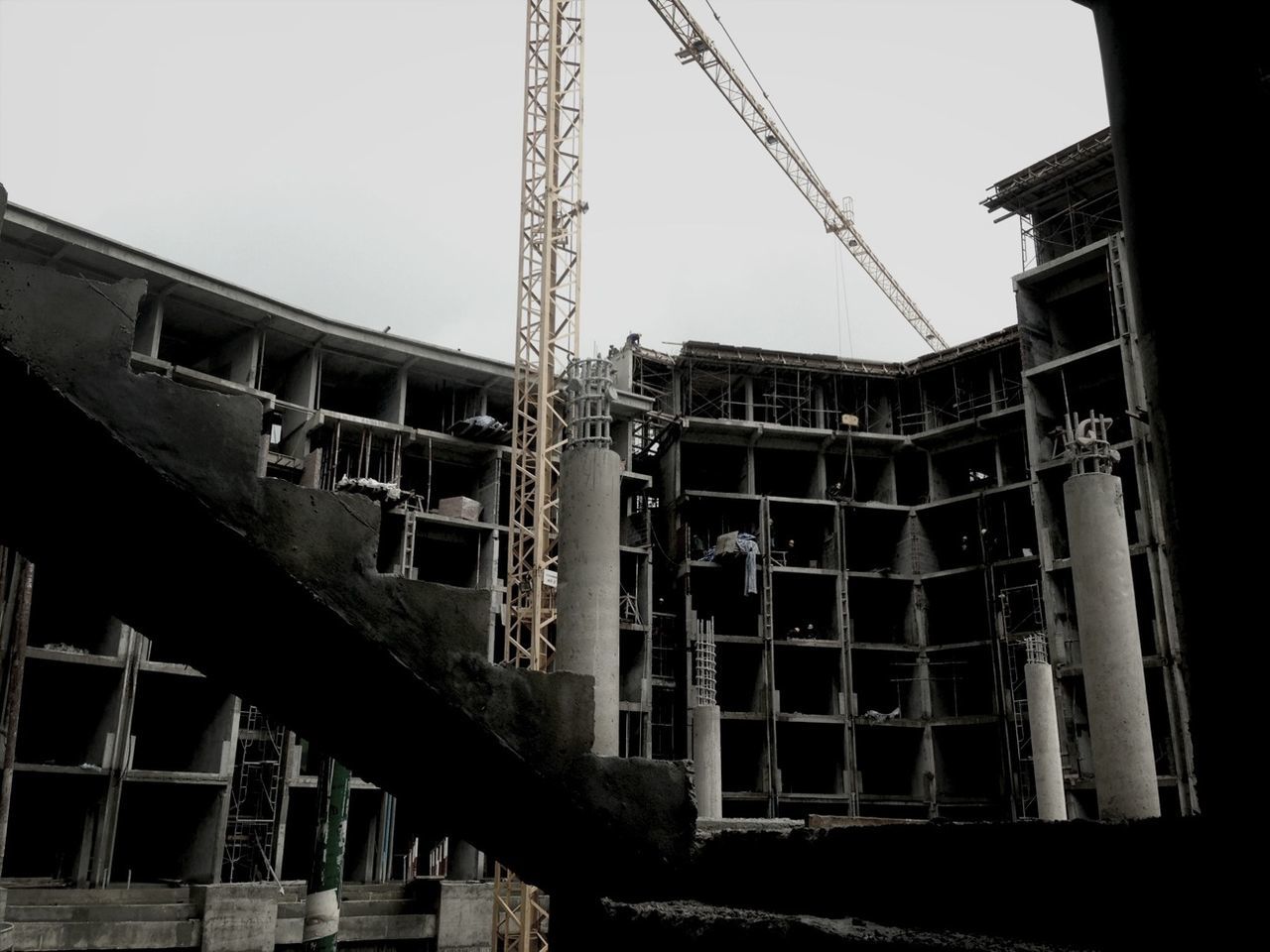 architecture, built structure, building exterior, low angle view, construction site, clear sky, construction, development, building, residential building, incomplete, crane - construction machinery, city, construction industry, industry, residential structure, outdoors, day, sky, no people