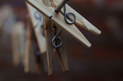 Close-up of metal hanging on wood