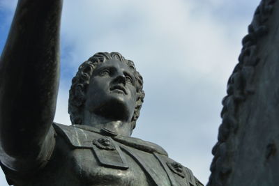 Low angle view of statue against sky