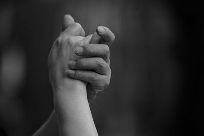 Cropped image of people with holding hands