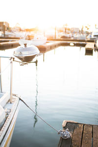 Sailboats moored in river against sky