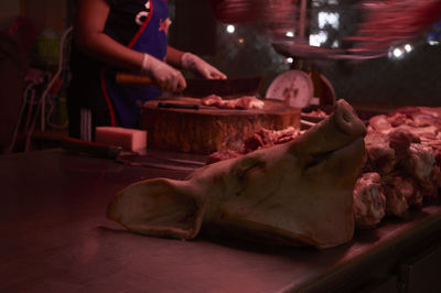 Midsection of butcher cutting meat