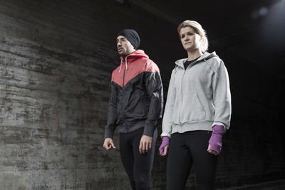 Sporty couple standing in tunnel