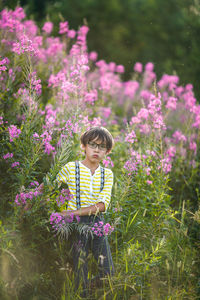 Woman with pink flowers on field