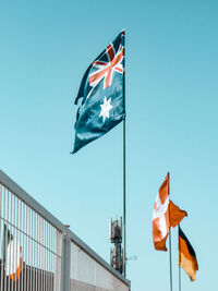 Low angle view of flags flag against clear sky