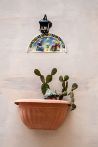 Sacred image and vase with plant on the facade of a house in malta