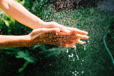 Midsection of man in water drops