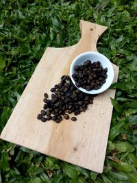 High angle view of fruits in container on wood