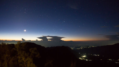 Scenic view of landscape against sky at night