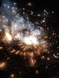 High angle view of firework display at night