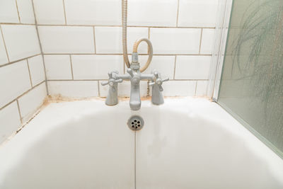 Low section of man standing in bathroom