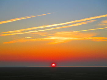 Scenic view of sea against romantic sky at sunset