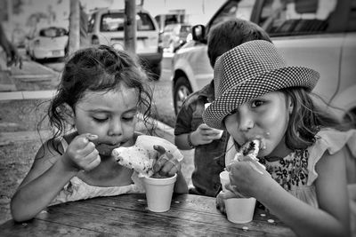 Close-up of girl eating food on table at cafe