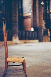 Close-up of empty chairs on table against building