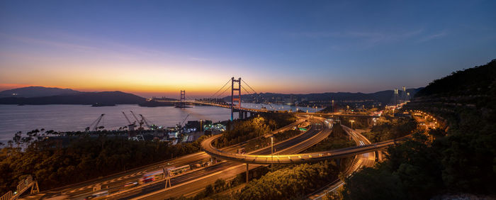 Panoramic view of bridge over sea against sky at sunset
