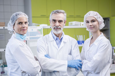 Portrait of three confident scientists in lab