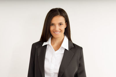 Portrait of businesswoman standing against white background