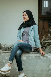 Portrait of a young woman sitting outdoors