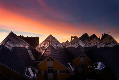 Low angle view of buildings against sky at sunset