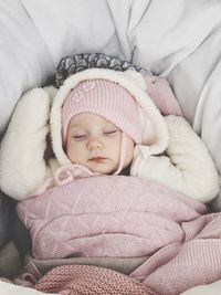 Close-up of cute baby sleeping in bed