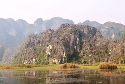 Scenic view of lake and mountains against sky