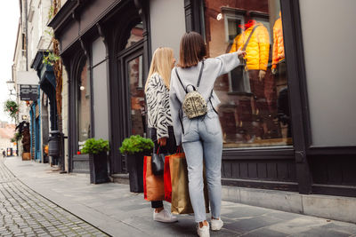 Rear view of woman standing on street