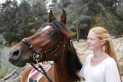 Portrait of woman riding horse