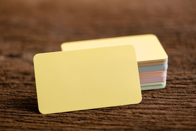 Close-up of colorful visiting cards on wooden table