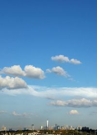 Cityscape against cloudy sky