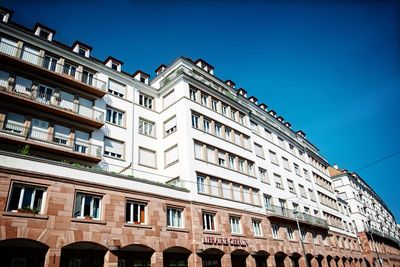 Low angle view of building against clear blue sky