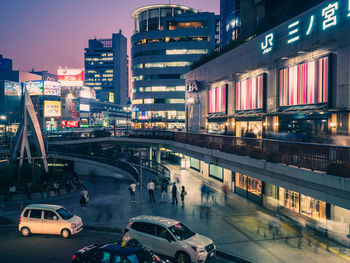 Cars on bridge in city at dusk