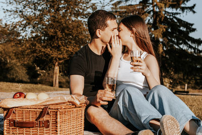 Young couple having a picnic in the park.