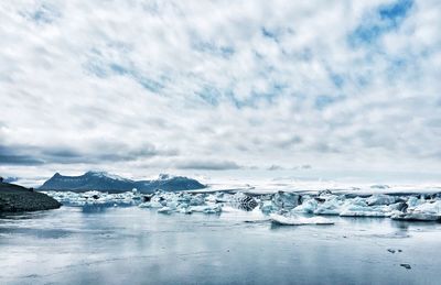 Scenic view of jokulsarlon against cloudy sky