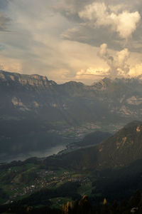 Scenic view of mountains against cloudy sky