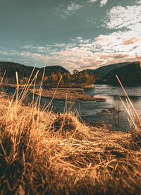 Scenic view of lake against sky during sunset