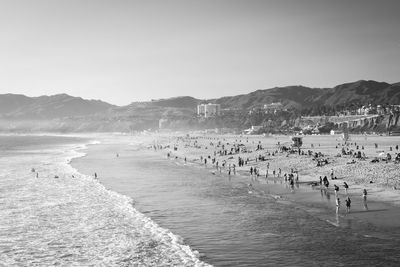 Group of people on beach against sky