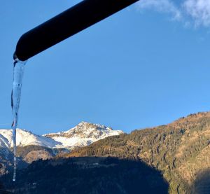 Scenic view of snowcapped mountains against clear blue sky