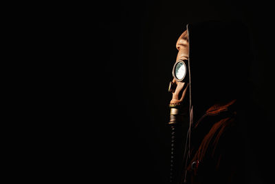 Studio portrait of a person with a totally unrecognizable mask