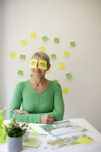 Portrait of smiling woman sitting on table