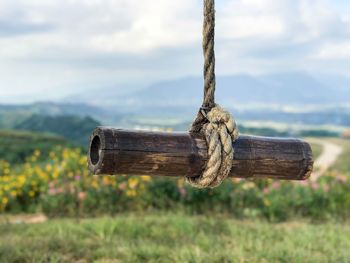 Close-up of rope tied up against sky