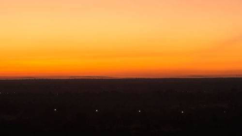 Scenic view of silhouette landscape against romantic sky at sunset