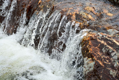 Water flowing through rocks in sea