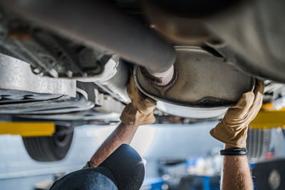 Midsection of man repairing car