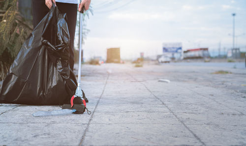 Low section of woman standing on street