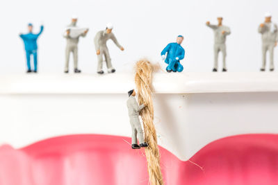 Close-up of dentures with figurines on white background